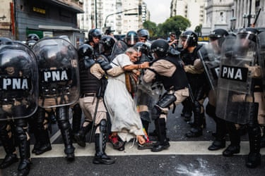 Riot police surround and detain Father Jorge Romero during a pensioners’ protest in Argentina