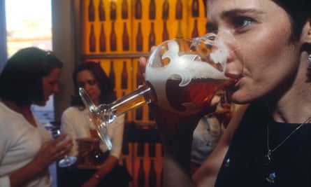 woman drinking beer in a bar in london 