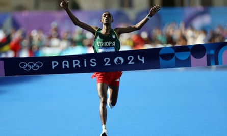 Tamirat Tola of Ethiopia celebrates as he crosses the finish line