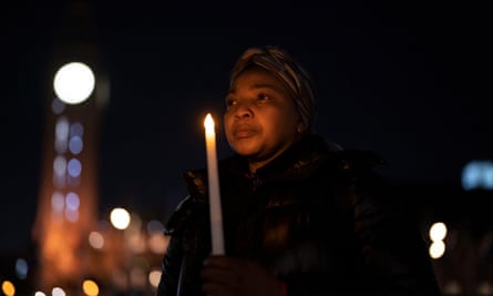 People at the vigil lit candles and held pictures of those who died
