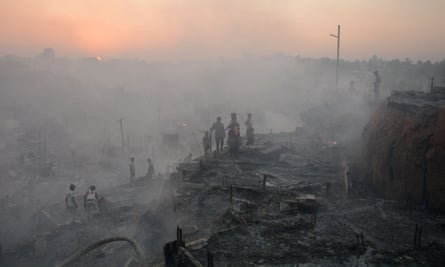Rohingya refugees search for their belongings after a fire broke out in their camp in Bangladesh on 5 March.