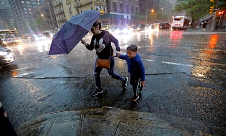 New Yorkers brave the severe thunderstorms that hit the city among tornado warnings in May 2018.