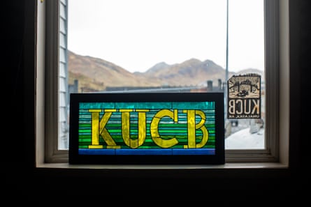 a sign for KUCB in a window