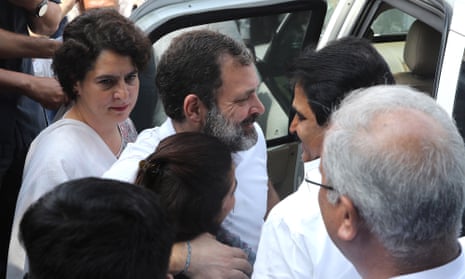 Rahul Gandhi hugs a party worker as his sister Priyanka Gandhi looks on, as they leave after addressing the media in Delhi
