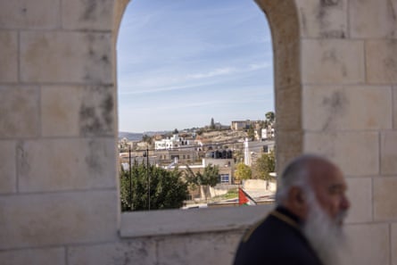 The view of a village through a stone window, a man in the foreground