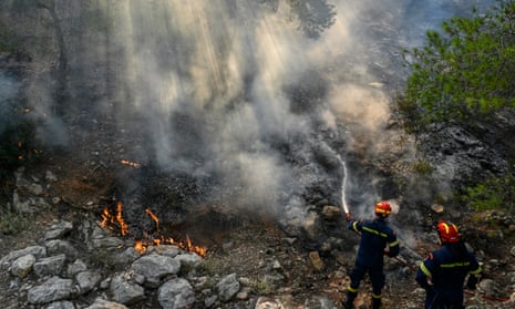 Firefighters try to control a wildfire in New Peramos, near Athens, Greece.