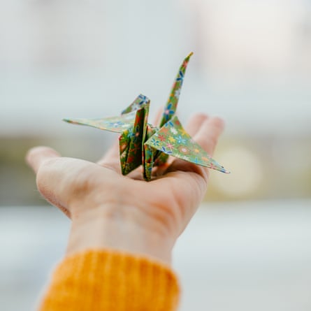 Female hand holding an origami crane