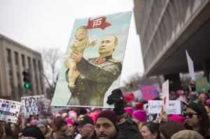 A man holds a Putin placard in Washington DC.