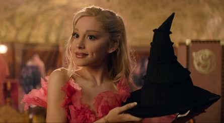 A woman holds up a witch’s hat