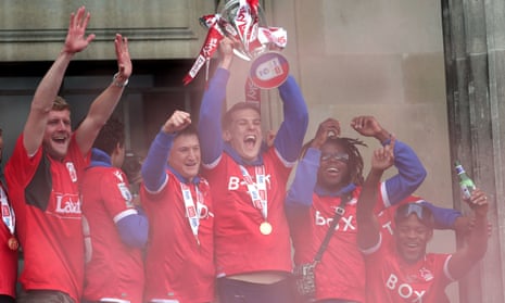 Nottingham Forest's Ryan Yates (centre) and teammates show off the playoff trophy in Old Market Square.