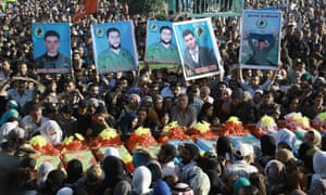 People mourning members of the Syrian Democratic Forces killed in Manbij.