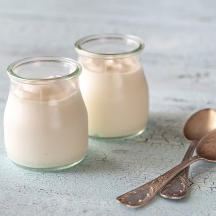 Two glass pots of Greek yoghurt closeup.