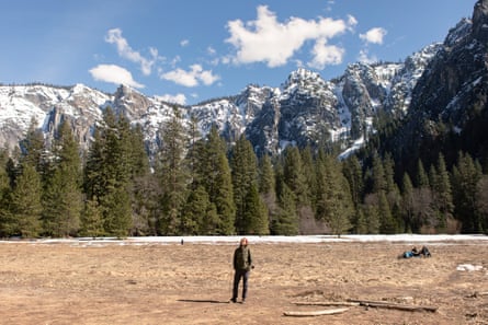 Visitors to Yosemite national park enjoy a clearing that is mostly devoid of snow.