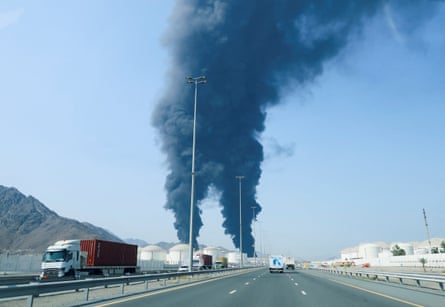 Black smoke billowing from an oil refinery