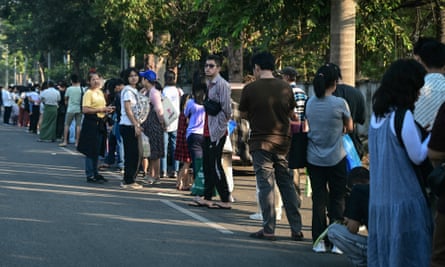 People queue for visas at the embassy of Thailand in Yangon on 16 February 2024.