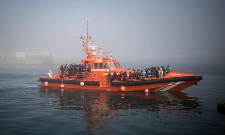 Migrants arrive on board a Spanish maritime rescue boat at the port of Tarifa