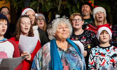 Miriam Margolyes with a group of Christmas carollers.