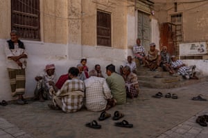 Men gather at dusk in the square in Shibam, Yemen