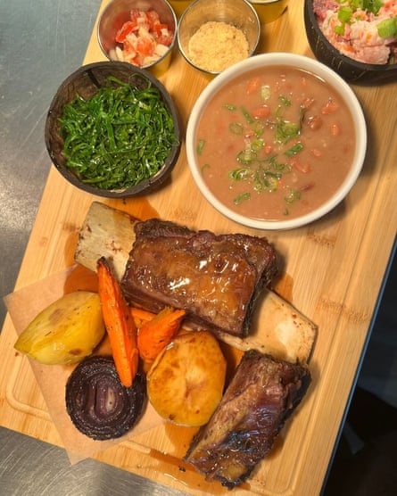 A selection of meats, vegetables and side dishes presented on a wooden board