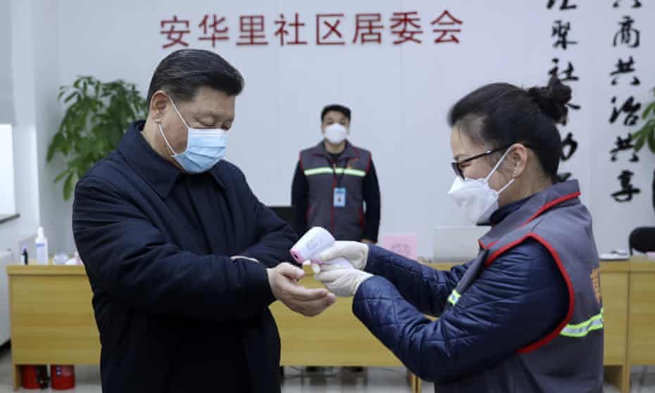 Xi Jinping wears a protective face mask as his temperature is checked in Beijing.