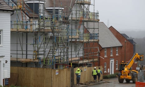 Builders work at a Barratt housing development in 2020