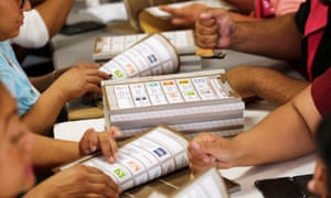 Employees of the National Electoral Institute (INE) count ballots at a warehouse where materials for the upcoming election are stored.