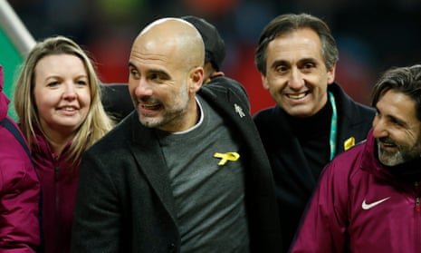 Pep Guardiola joins the post-match celebrations while wearing the pro-Catalonia yellow ribbon.