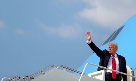 Donald Trump waves as he boards Air Force One to travel to South Dakota.