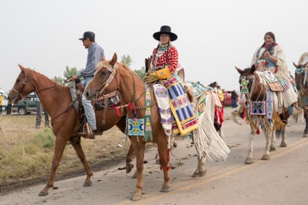 JoRee LaFrance rides in the parade during the 100th Annual Crow Fair Celebration Powwow and Rodeo in Crow Agency, Mont. on Sunday, August 19, 2018.