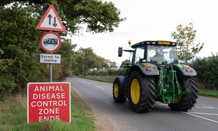 Tractor passing an Animal Disease Control Zone sign
