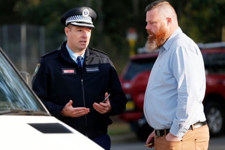 Detective inspector Matt Zimmer talks with Member for Hunter Dan Repacholi near the scene of a bus crash in the NSW Hunter Valley, Australia. Monday, June 12, 2023.