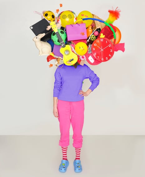 Photomontage of a woman in a purple sweatshirt, one hand on hip, pink sweatpants rolled up showing red and white striped socks, pale blue crocs with a mass of objects – clock, guitar, football, rabbit, computer, hula-hoop etc – in place of a head
