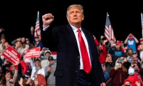 Donald Trump holds up his fist as he leaves the stage after a rally in Valdosta, Georgia, on 5 December 2020. 