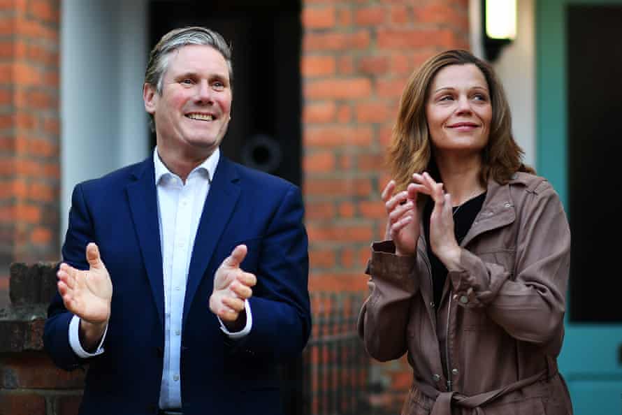 Labour leader Sir Keir Starmer and his wife Victoria applaud for key workers outside their home in London.
