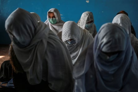 A group of girls fully covered in hijabs with faces obscured