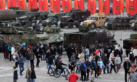 People walk past military vehicles captured in Ukraine, being exhibited at Poklonnaya Hill on Sunday, in Moscow, Russia.