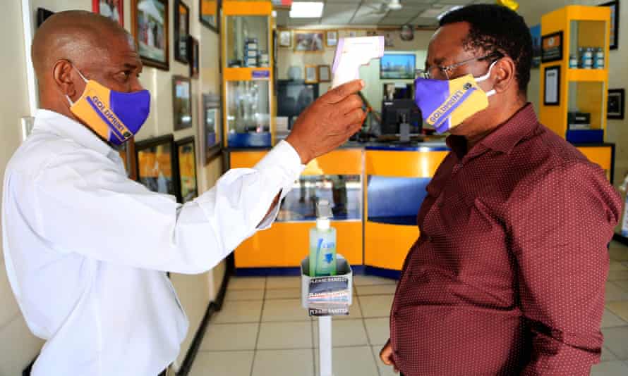 A man has his temperature checked in a shop Harare, Zimbabwe, in October.