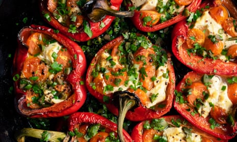 Baked red pepper halves, stuffed and with chopped herbs on top