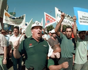 Fired waterfront workers and other union supporters march in front of Sydney’s Darling Harbour docks in April 1998.