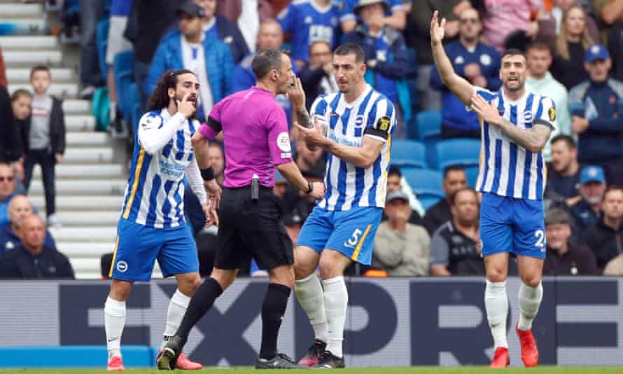 Brighton players appeal to Stuart Attwell for a penalty against Leicester