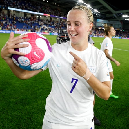 Beth Mead of England picks up the match ball after her hat trick.