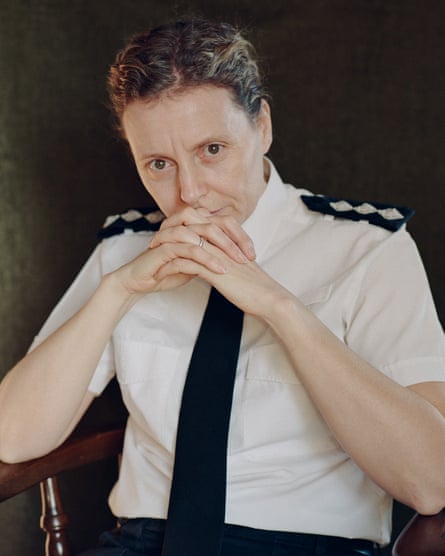 Chief inspector Sharon Baker in a short-sleeved uniform shirt, sits with her hands interlocked near her chin