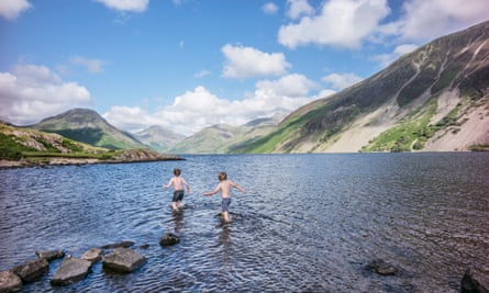 Wild swimming boys in Wast Water the deepest and coldest of all the lakes.