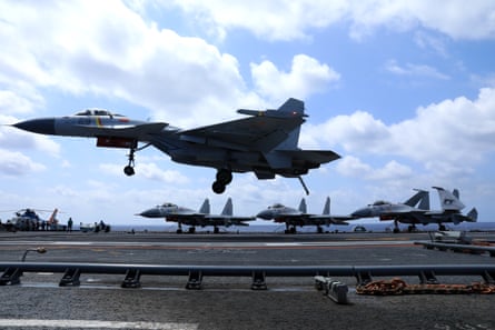 A fighter jet lands on the flight deck on the aircraft carrier Liaoning during a drill on 8 April 2021 in South China Sea.