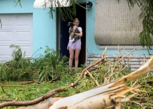 a young girl holds a dog