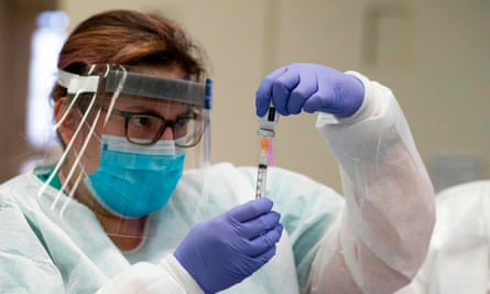 A nurse prepares a dose of the Moderna coronavirus vaccine at South Bronx educational campus in New York