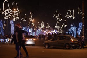 People walk amid brightly colored decorations during New Year celebrations January 1, 2017 in Abidjan. / AFP PHOTO / SIA KAMBOUSIA KAMBOU/AFP/Getty Images