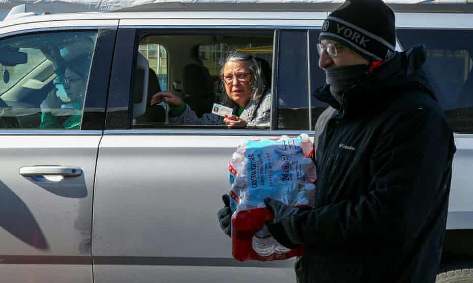 Volunteers hand out boxes of water bottles at the Schlitterbahn Waterpark car park in Galveston, Texas.