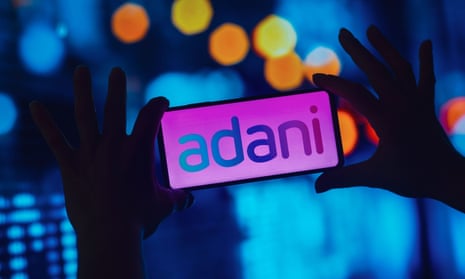 The Adani Group logo on a smartphone