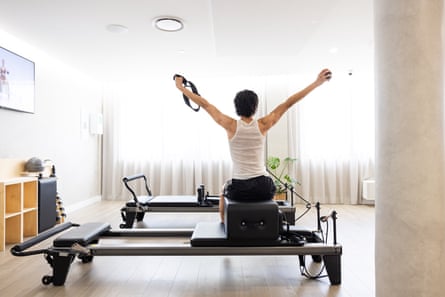 My first time at teacher-less pilates: 'There is a soothing quality to the digital instructor's voice, like an early childhood educator or a cult leader' | Pilates | The Guardian